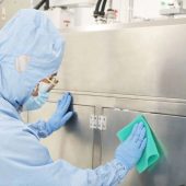 A person is cleaning a surface with Sahara Sponge